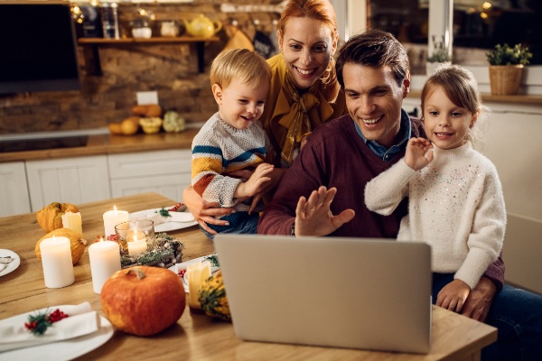 Family sitting in front of non branded Notebook PC