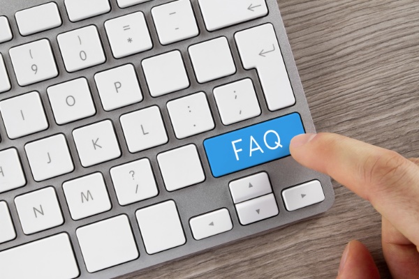 finger pressing FAQ button on keyboard